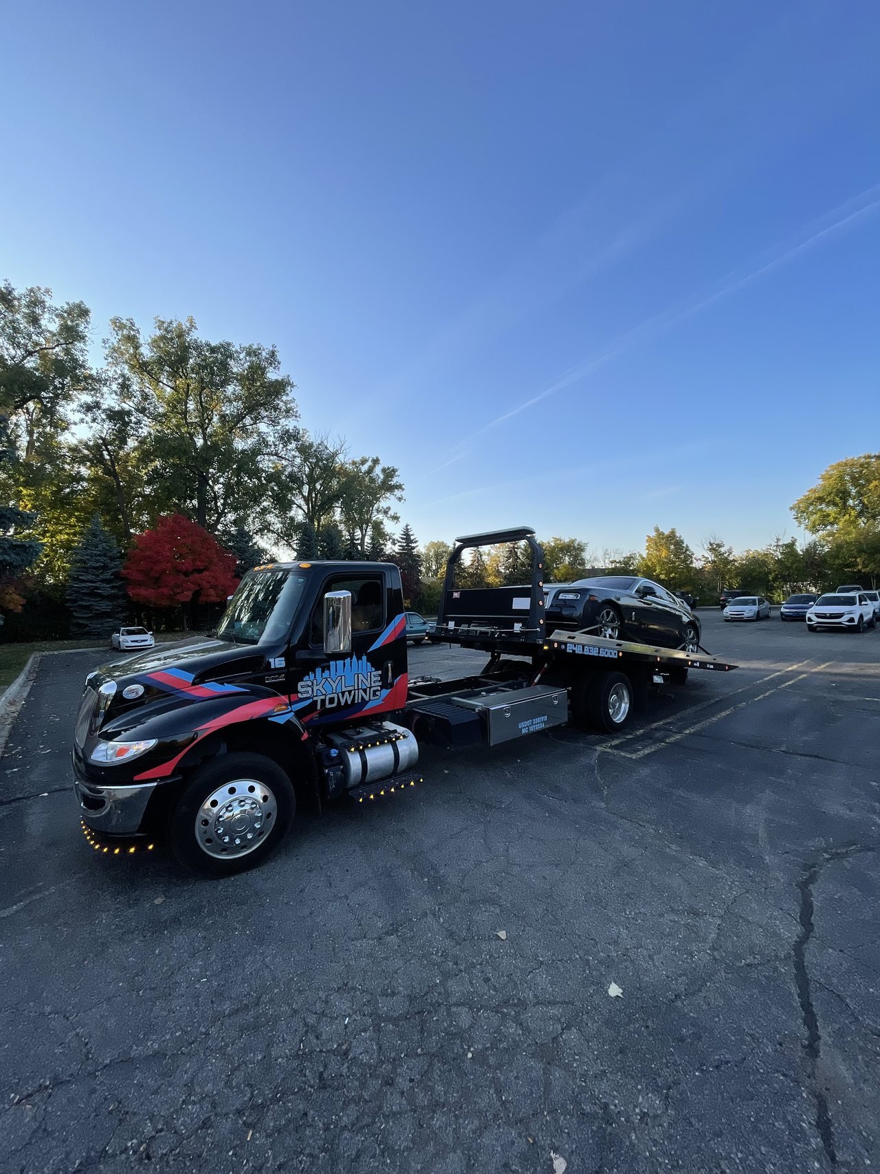 Skyline Towing flatbed tow truck in a parking lot